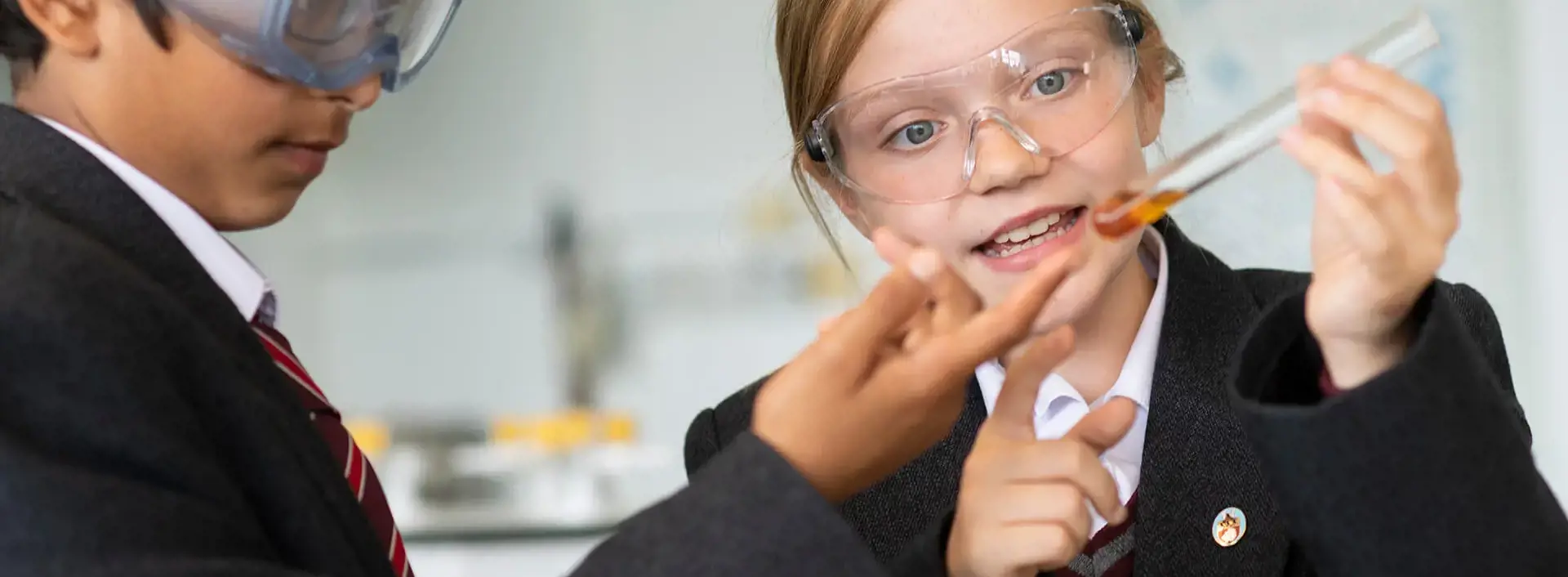 Pupils in science class, holding a test tube