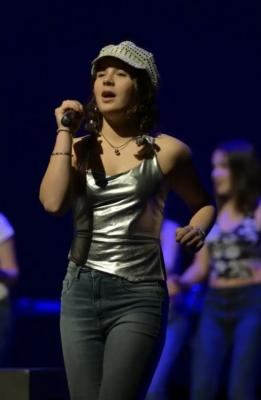 A female student singing on stage at Kent College