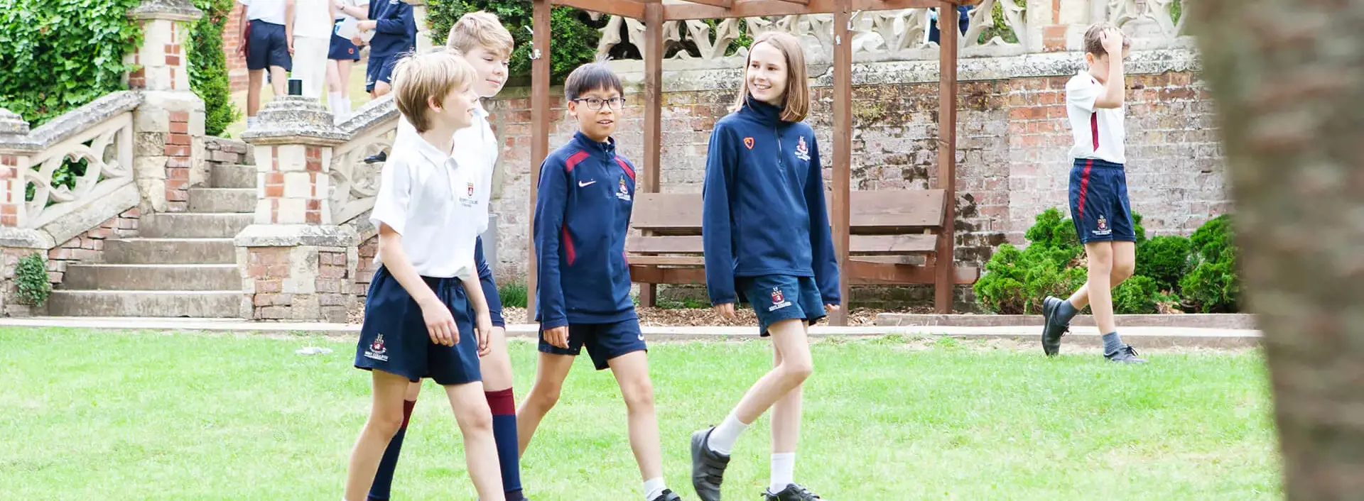 Junior School pupils walking in the school grounds