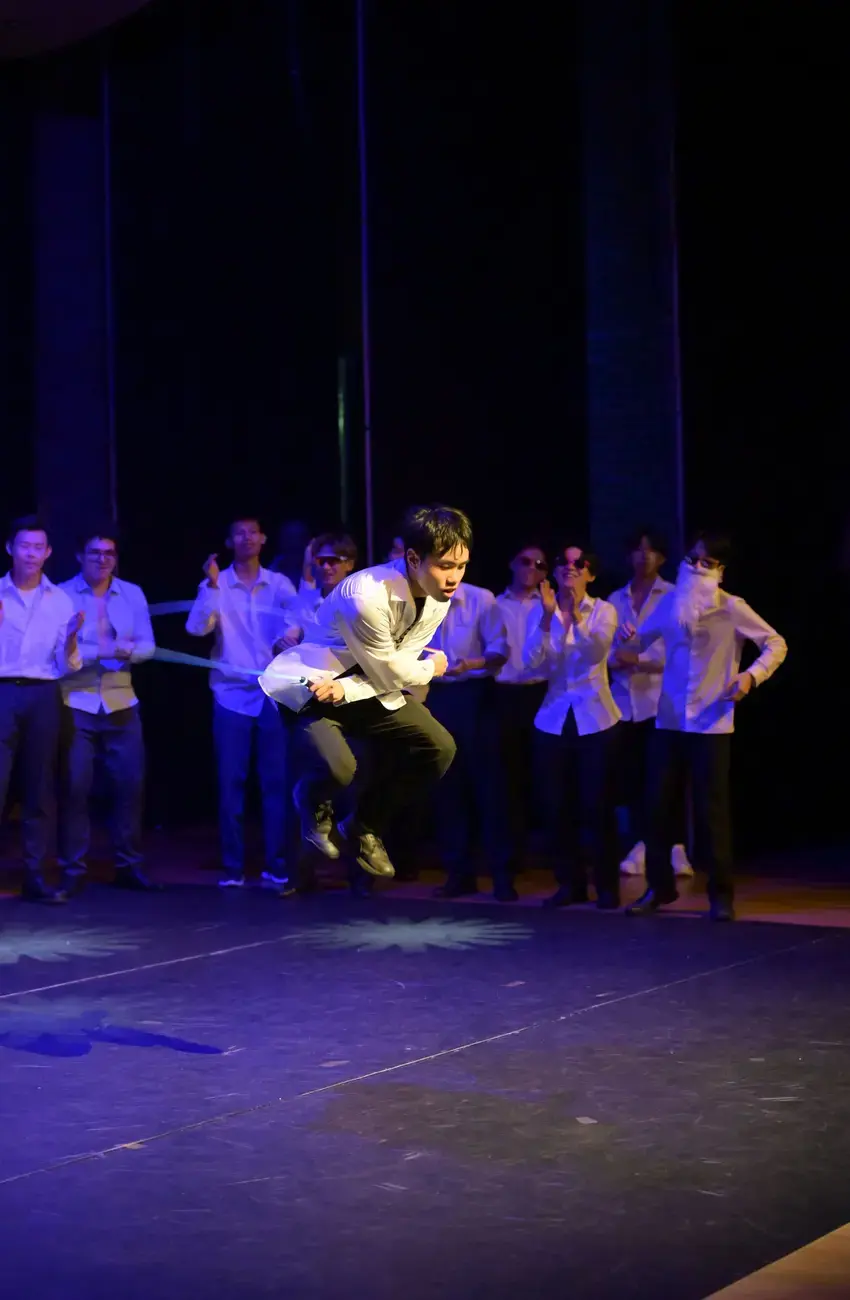 A male student at Kent College performing a jumping routine